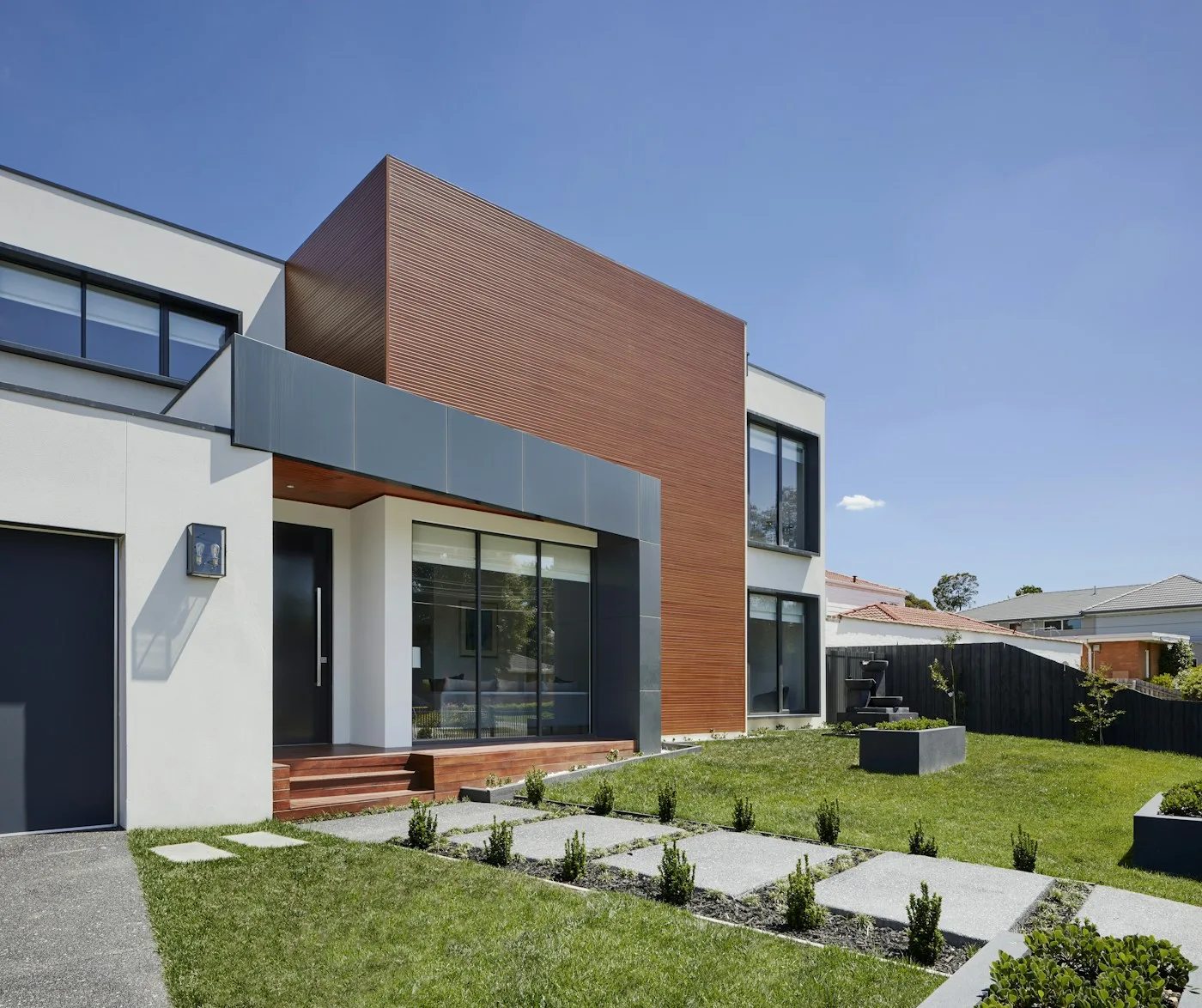 Modern house opening onto a green garden